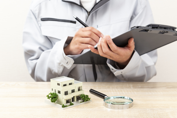 A house model and a woman wearing work clothes